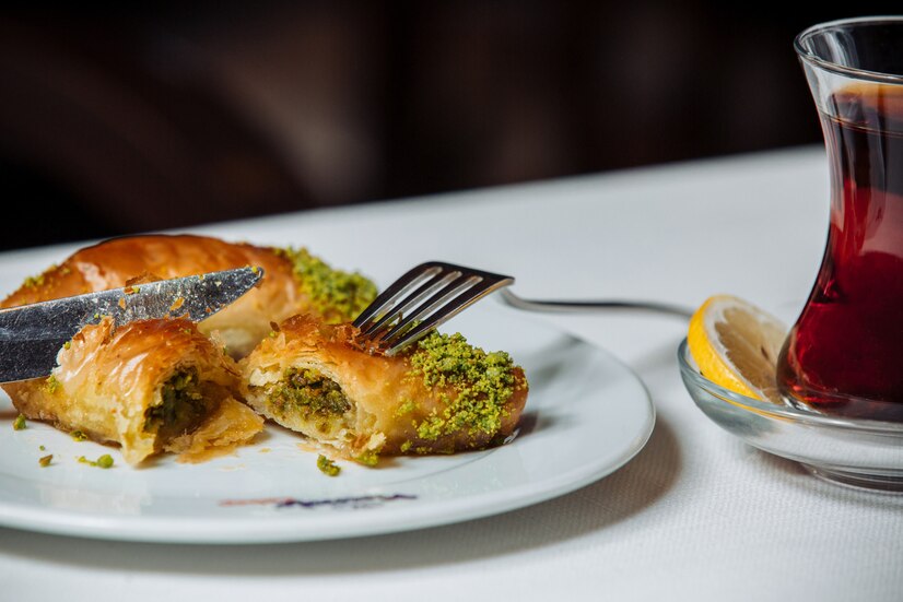 A stunning Baklava Cake, garnished with pistachios and a honey drizzle, ready to impress!